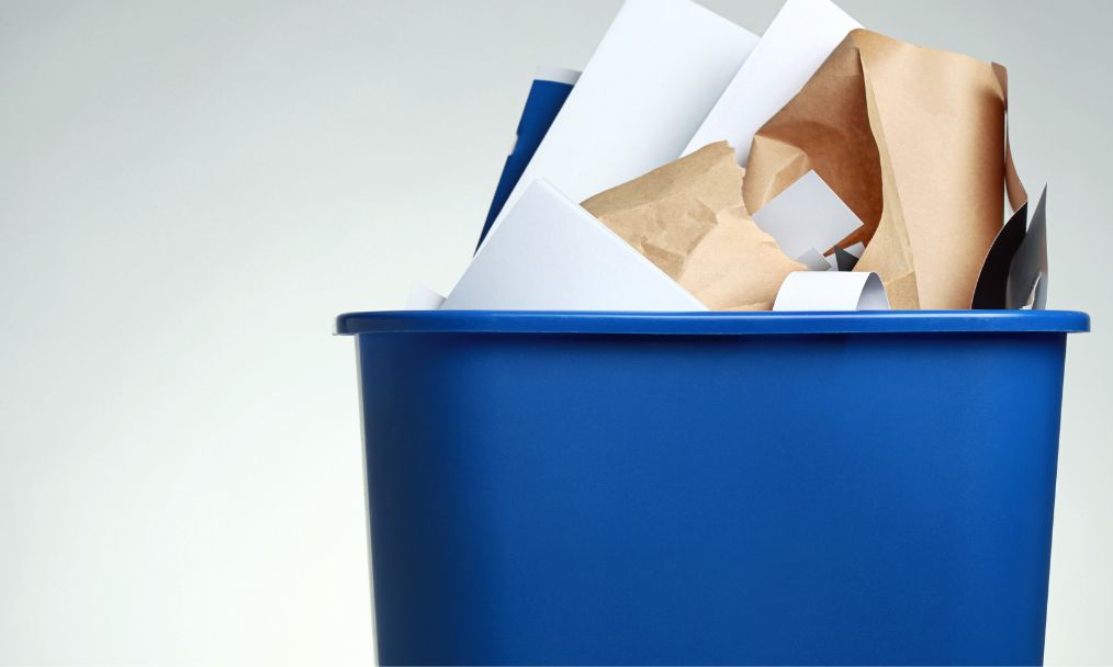 a recycling bin full of paper